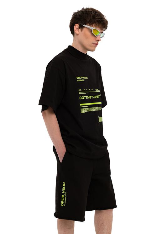 Remera negra con tipografía verde neón estilo código técnico en el frente
